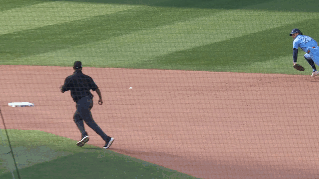 An animated gif of Ernie Clement making a diving stop and throw from his knees
