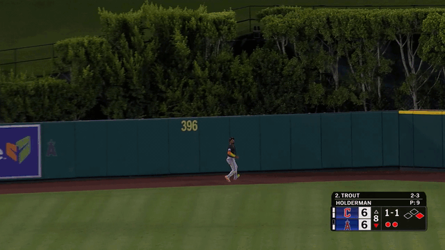 An animated gif of Angel Martínez running over to make a leaping catch in front of the wall
