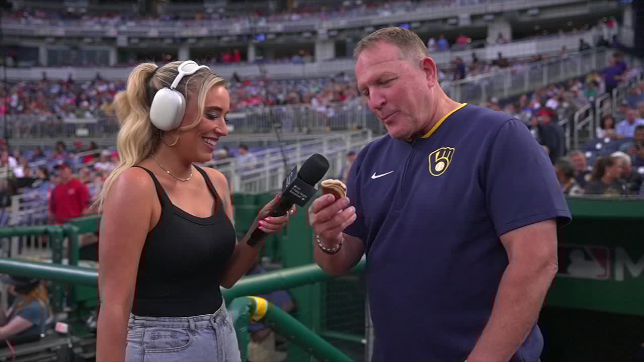 Brewers manager Pat Murphy eats a pancake while doing an in-game TV interview