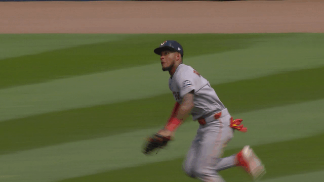 An animated gif of Ceddanne Rafaela making a diving, tumbling catch in left-center field