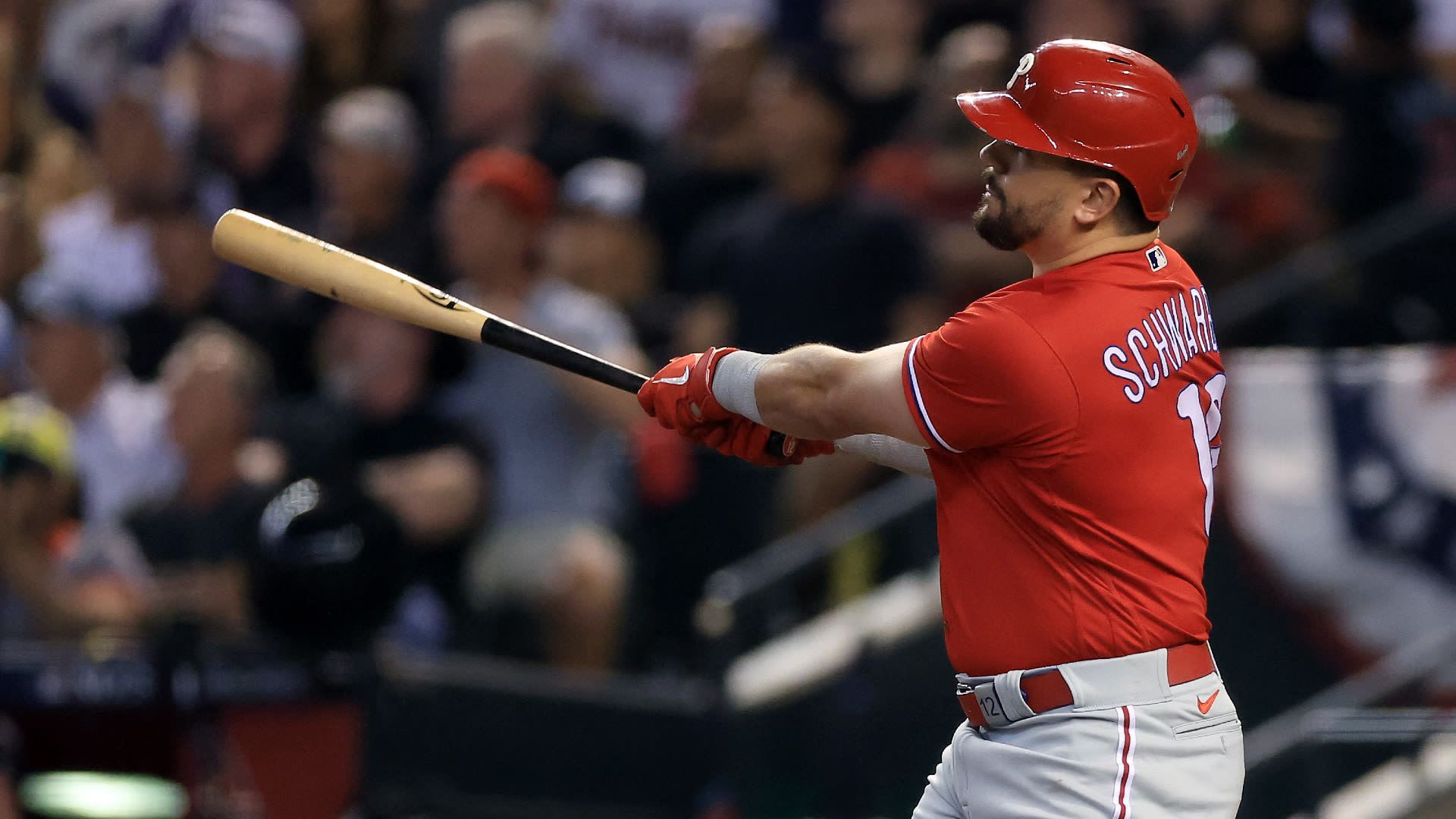 Kyle Schwarber follows through on a home run swing