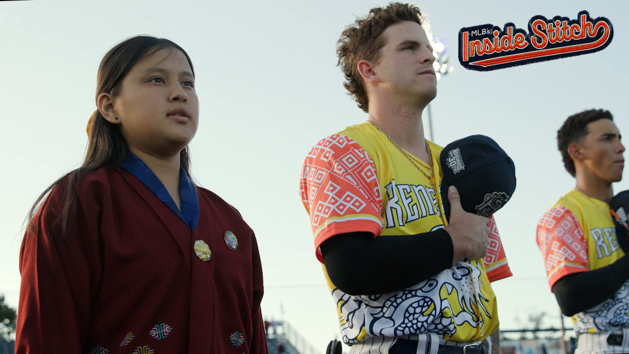 A female player from Bhutan and a Hudson Valley Renegades player stand for the national anthem