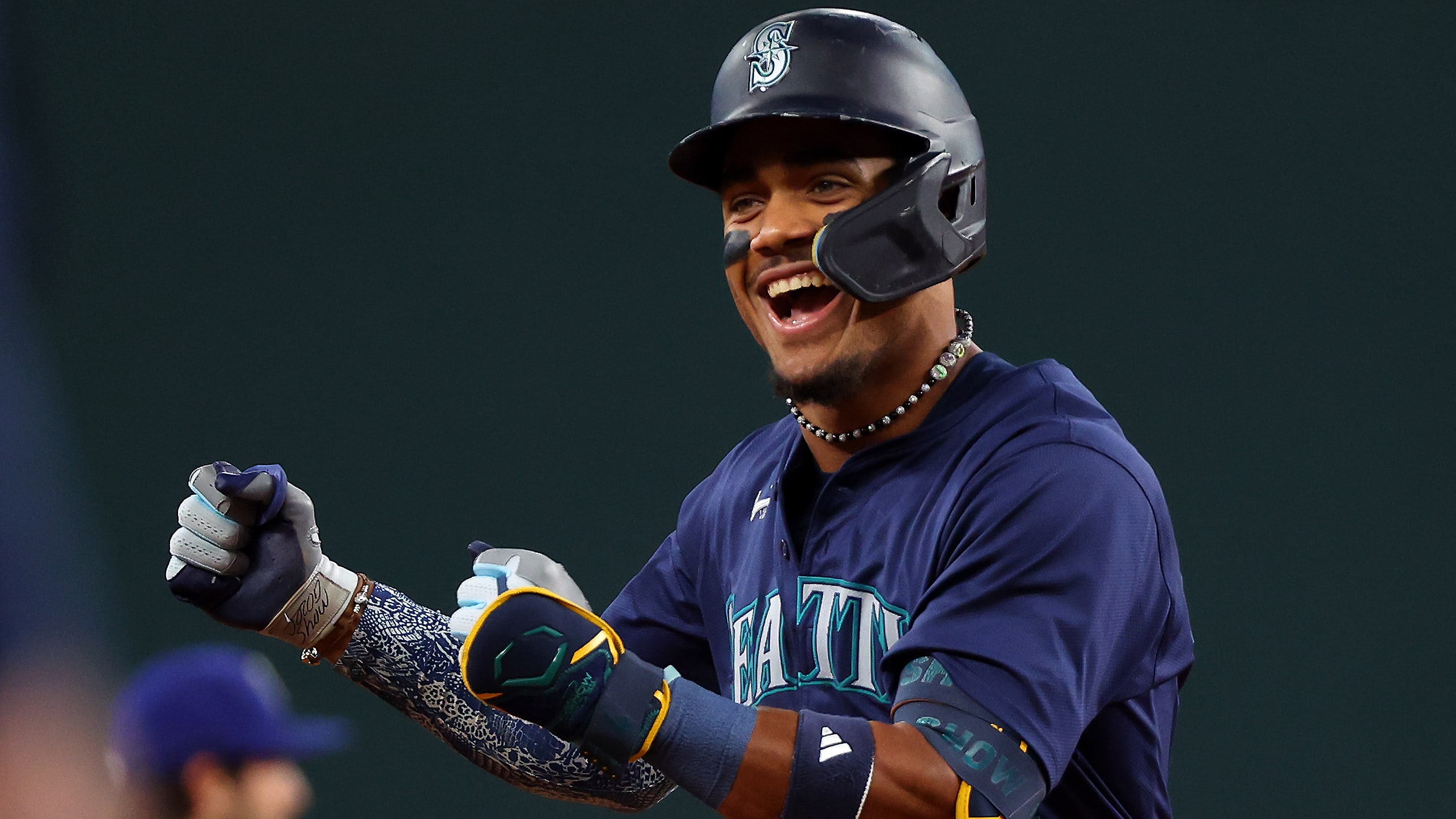 Julio Rodríguez celebrates after leading off the game with a home run