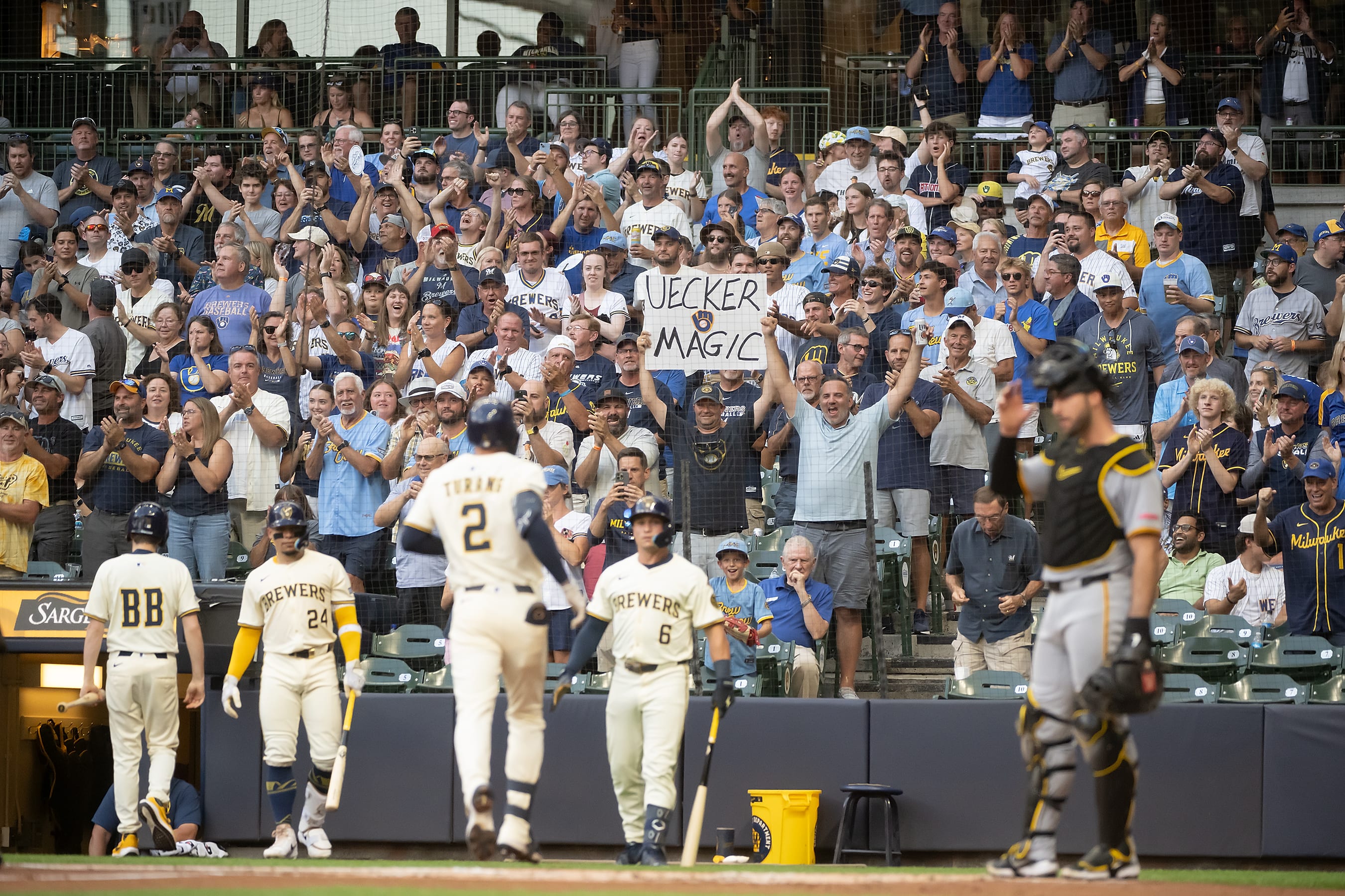 Brewers fan holds 'Uecker Magic' sign