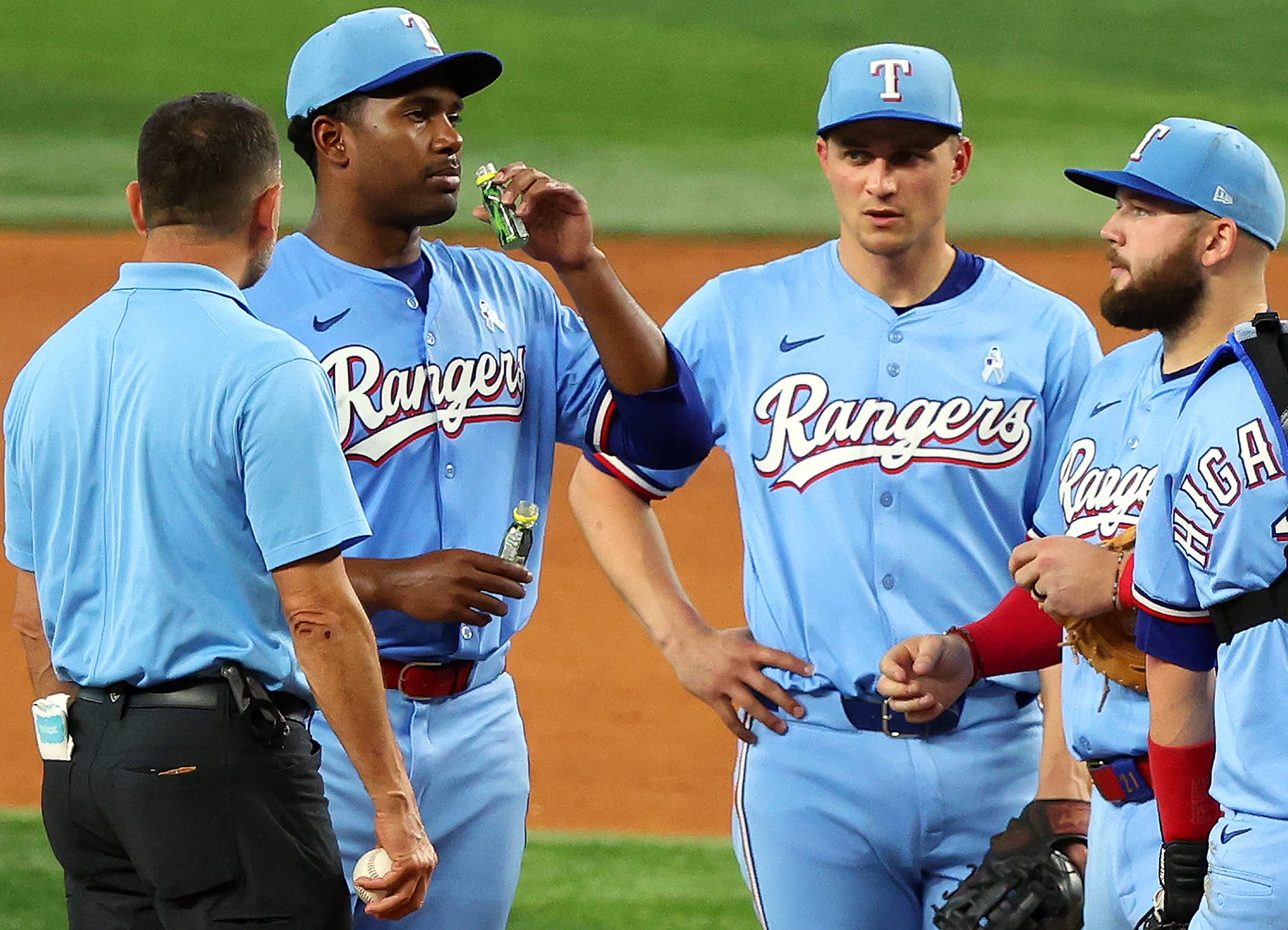 Kumar Rocker tries some pickle juice while Corey Seager (second from right) and others look on with cautious optimism
