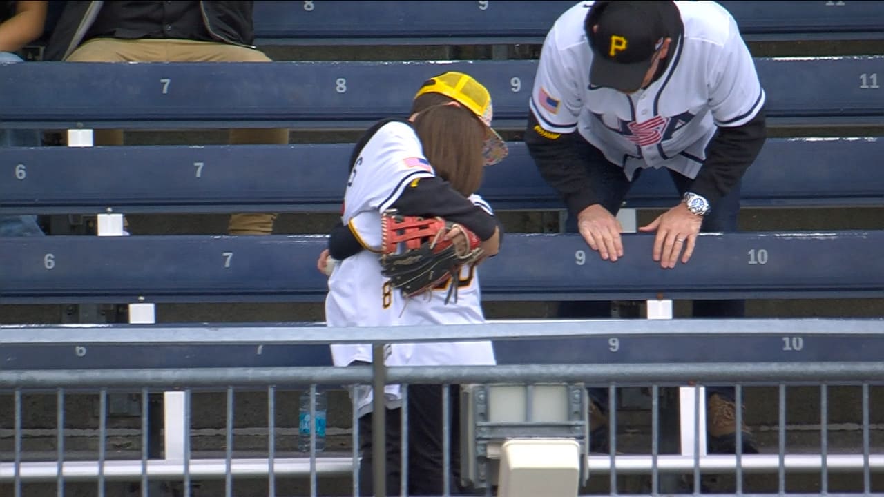 Two young fans hug after getting a baseball