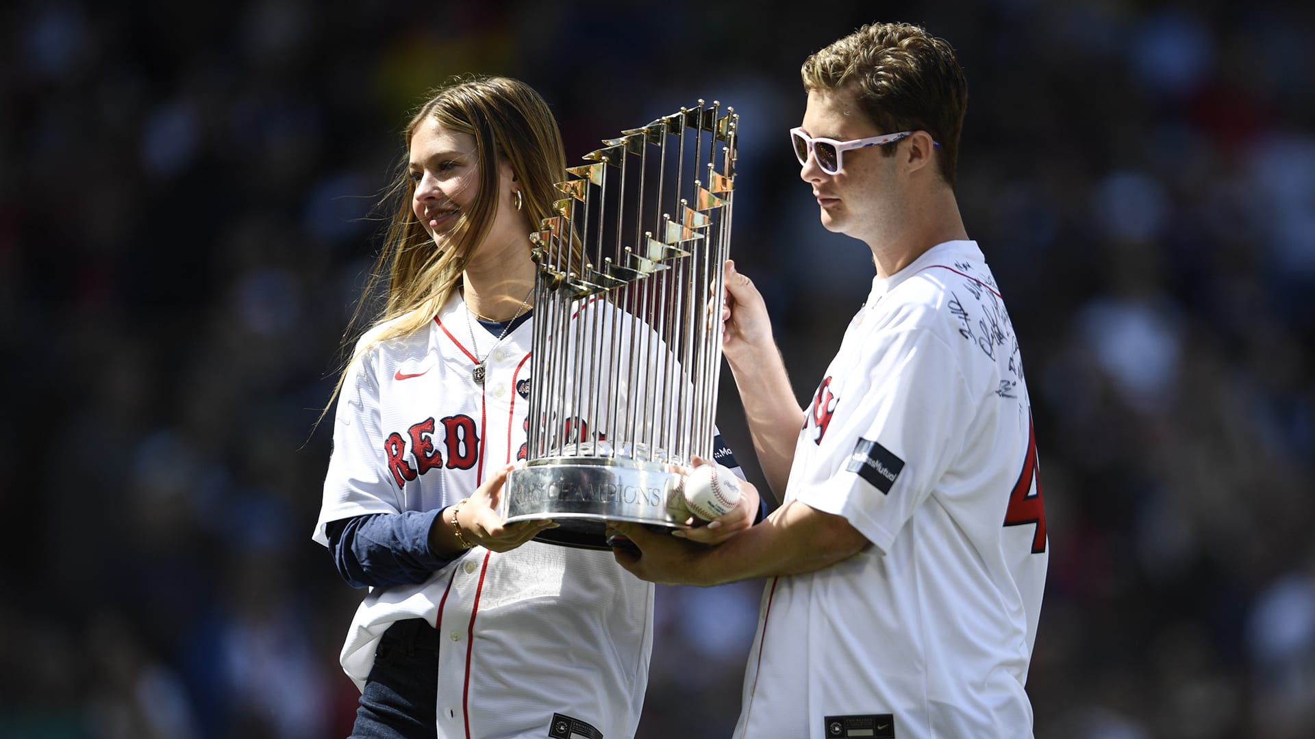 Brianna and Trevor Wakefield hold up the 2004 World Series trophy