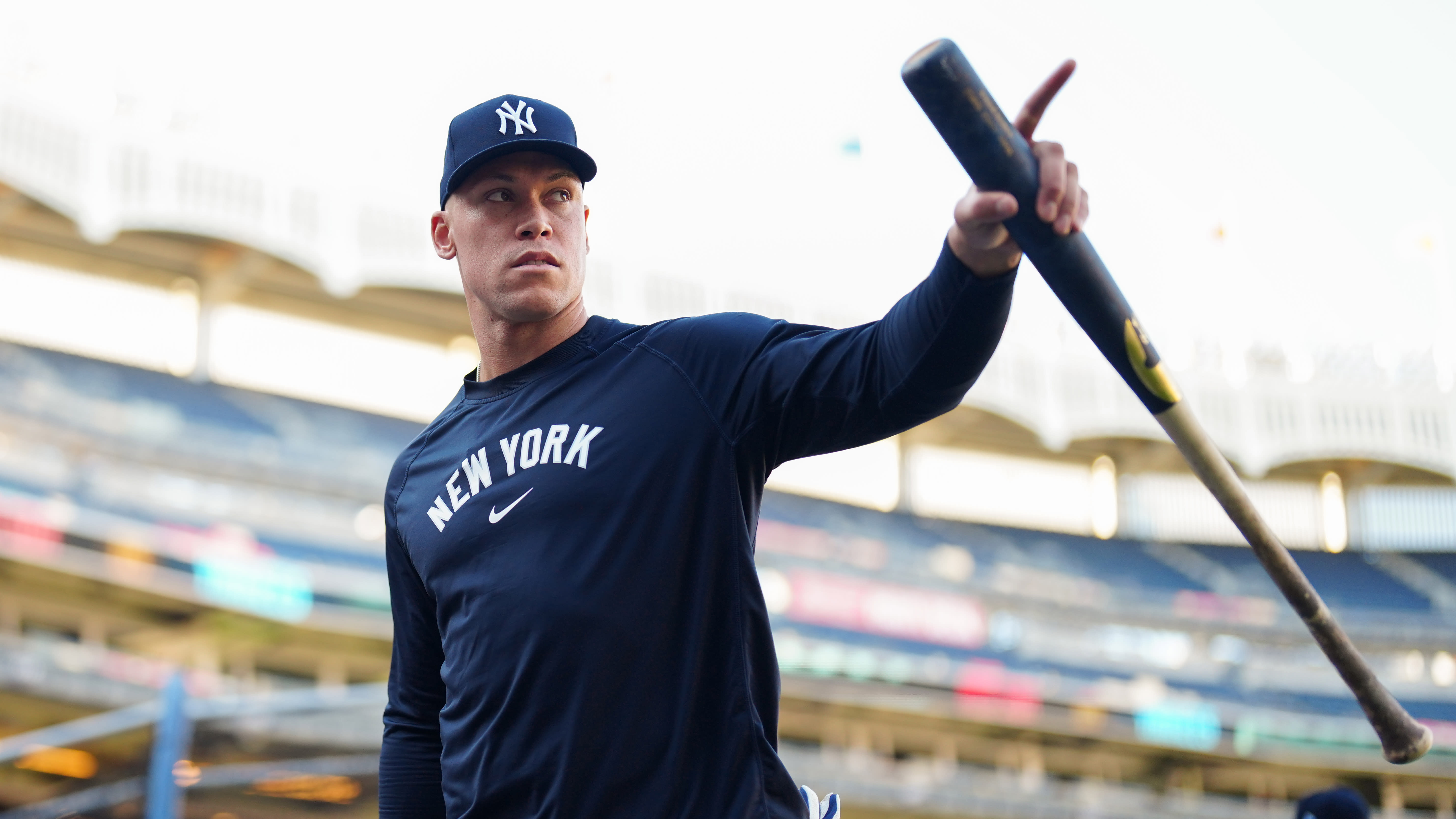 Aaron Judge points to the stands while holding a bat