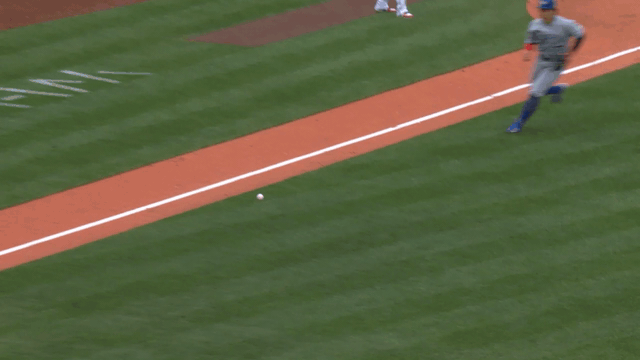 An animated GIF of Kazuma Okamoto making a barehanded throw to first
