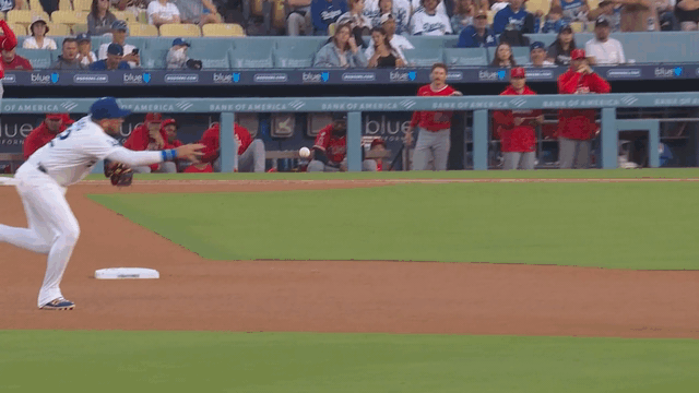 An animated gif of Miguel Rojas barehanding a ball and making a throw to first