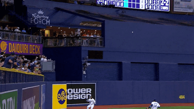 An animated gif of Cedric Mullins making a catch before crashing into the wall and losing his cap