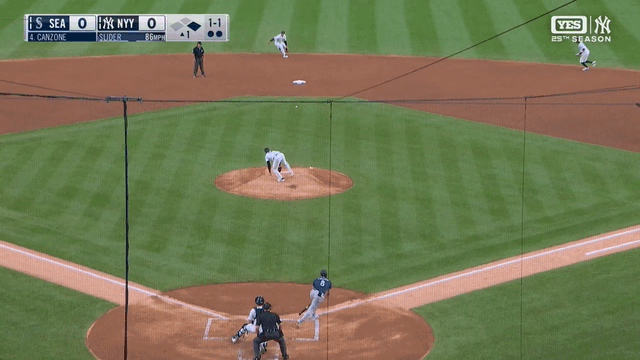 An animated gif of George Lombard Jr. adjusting to a bad bounce to grab a grounder with his bare hand and throw to first