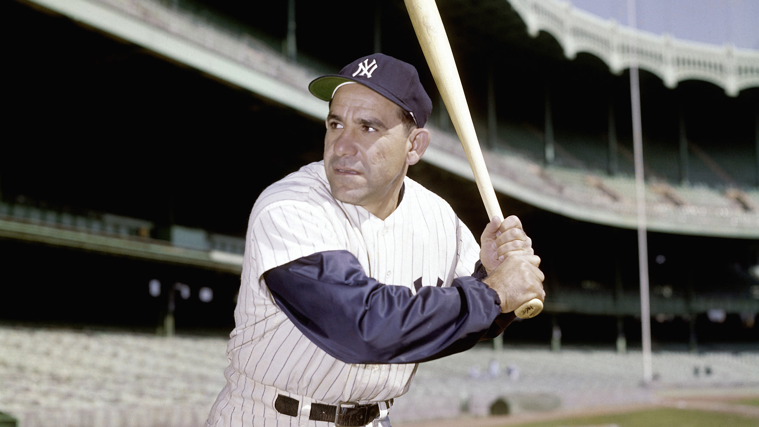 Yogi Berra holds a baseball bat