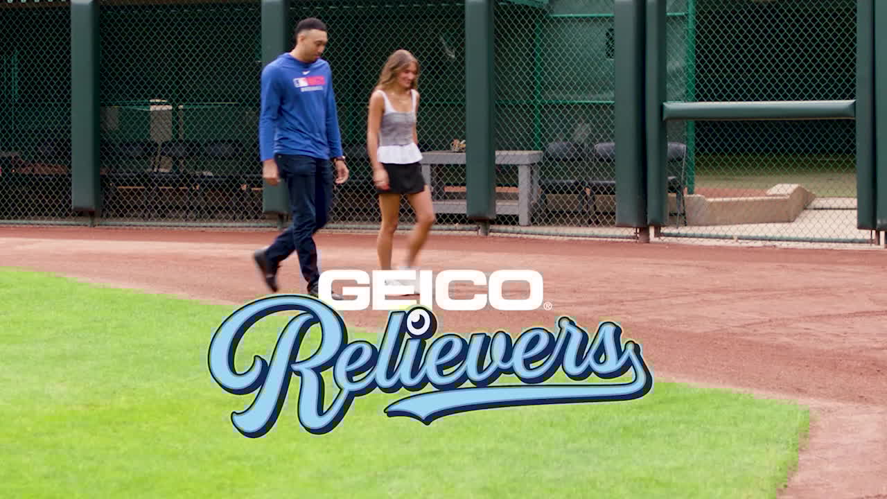 A screengrab of Edwin Díaz and Kait Maniscalco walking on a baseball field with the text GEICO Relievers