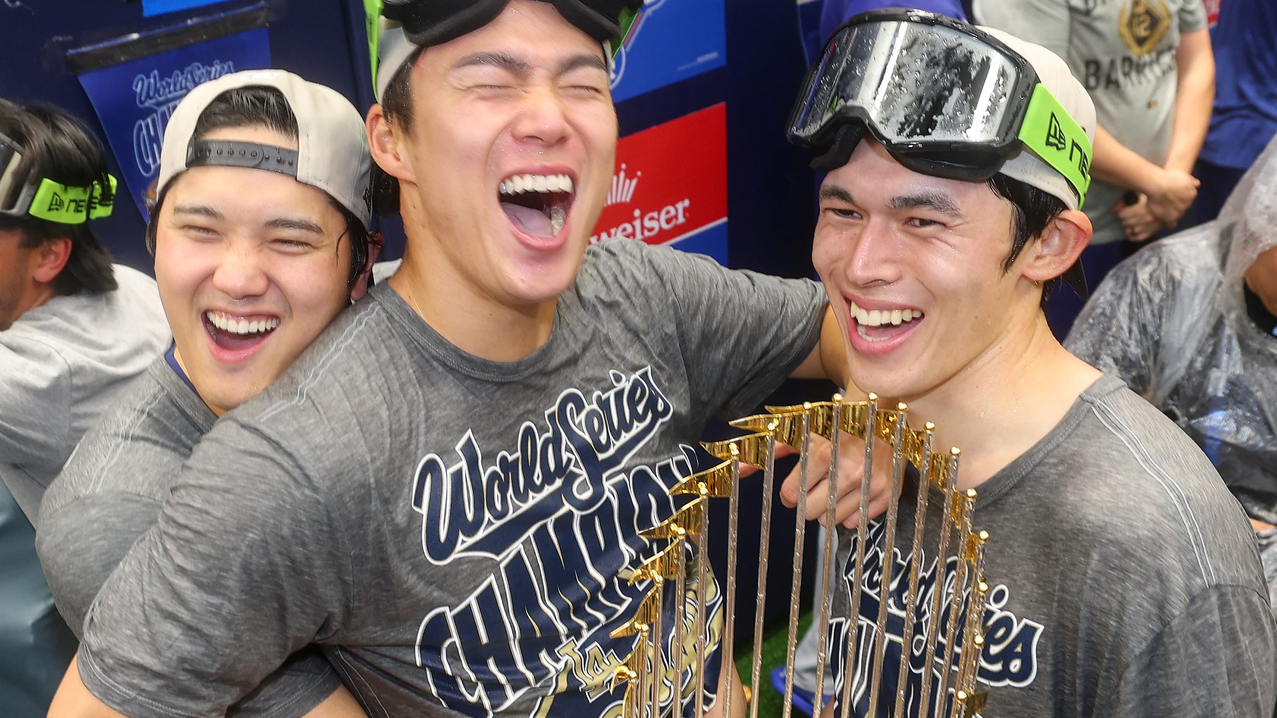 Shohei Ohtani, Yoshinobu Yamamoto and Roki Sasaki with the World Series trophy