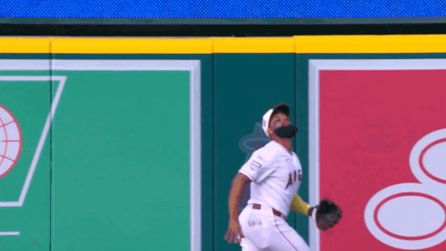 An animated gif of Jo Adell making a leaping catch at the wall