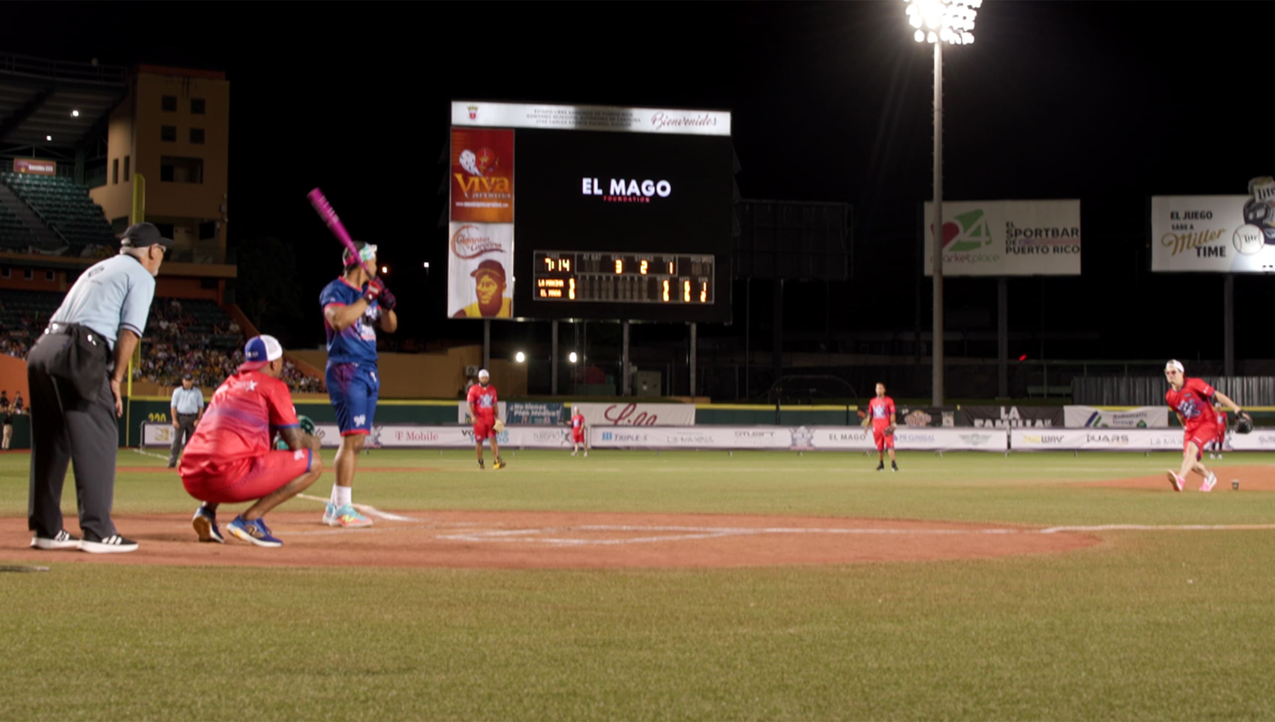 Francisco Lindor bats against Enrique Hernández during a charity softball game