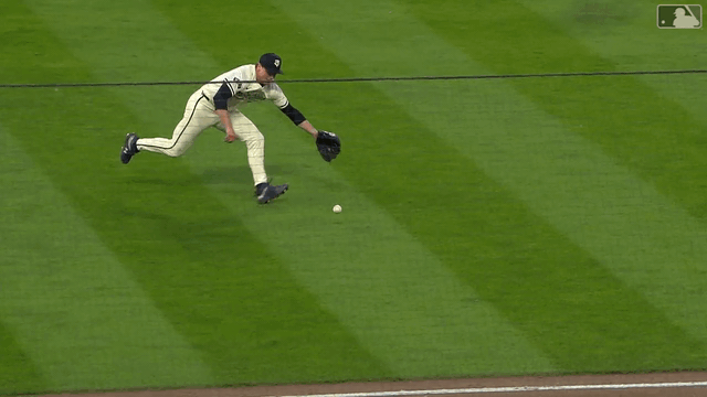 An animated gif of Twins pitcher Louis Varland making a tumbling, rolling stop and toss to first base
