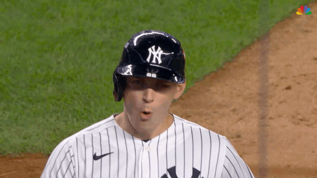 An animated gif of Ben Rice getting a handshake from a teammate after his grand slam