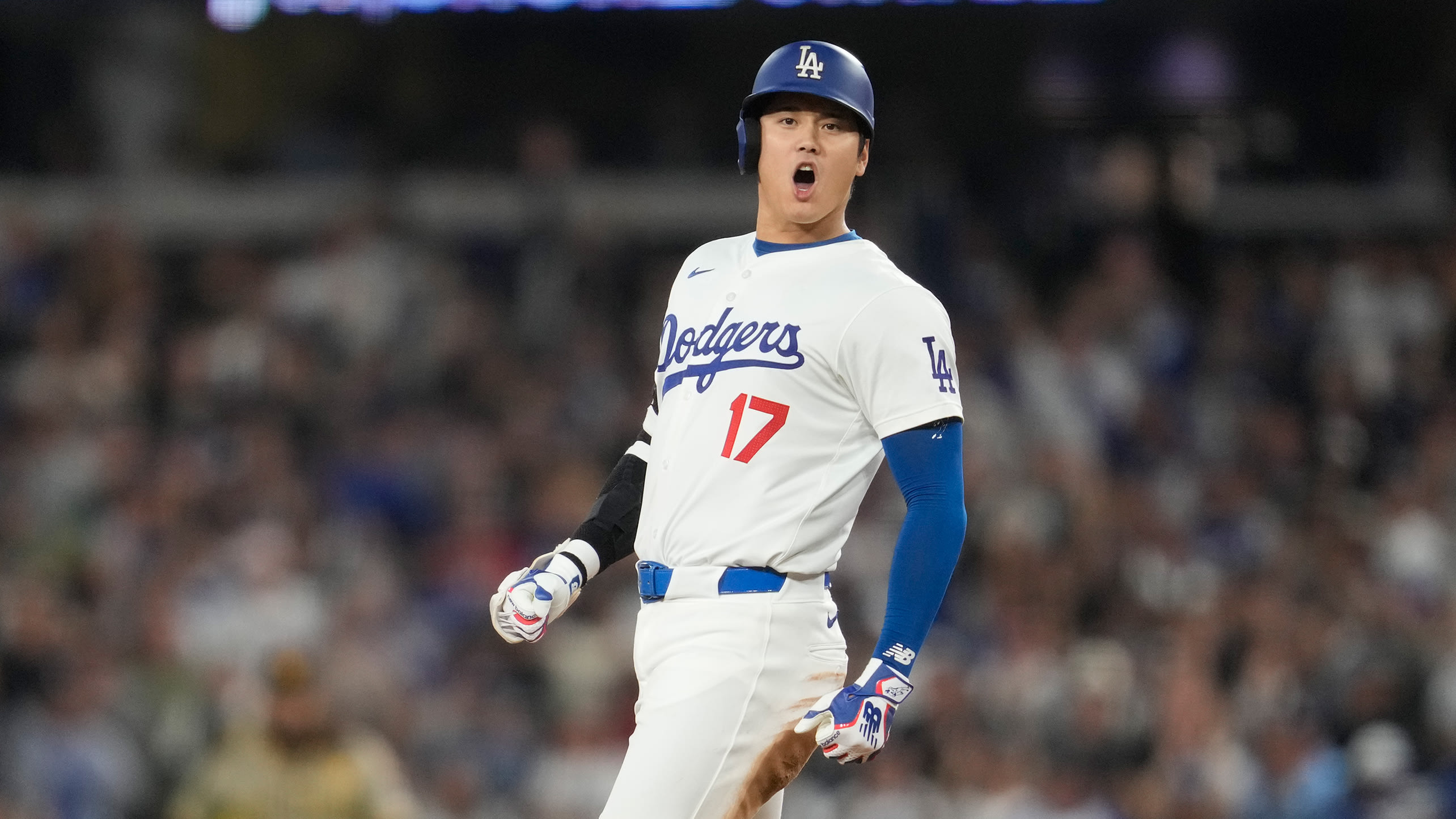 Shohei Ohtani shouts toward the dugout as he pulls into second base