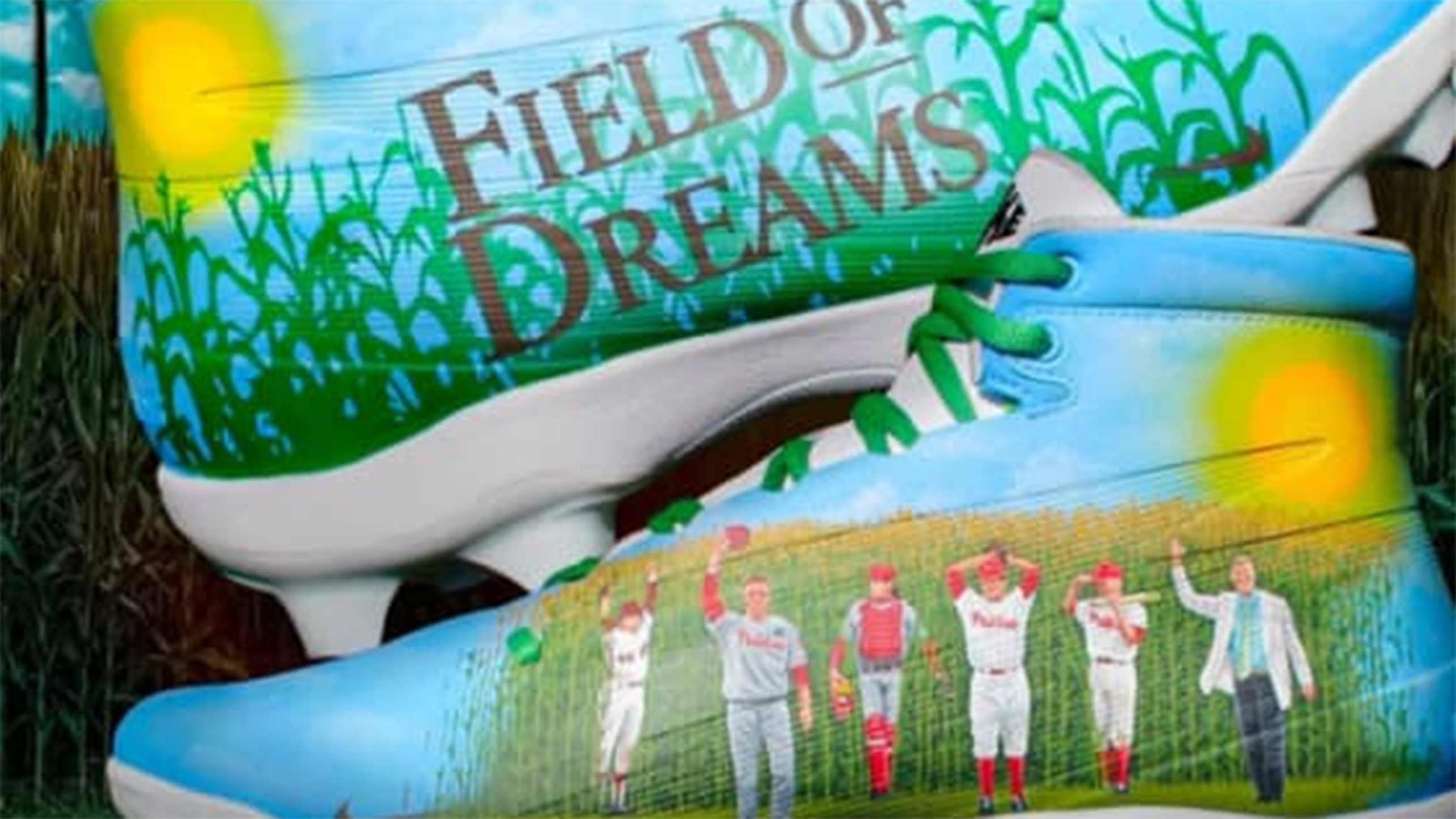 Cleats depicting the Field of Dreams logo over corn on one side and Phillies walking out of the corn on the other