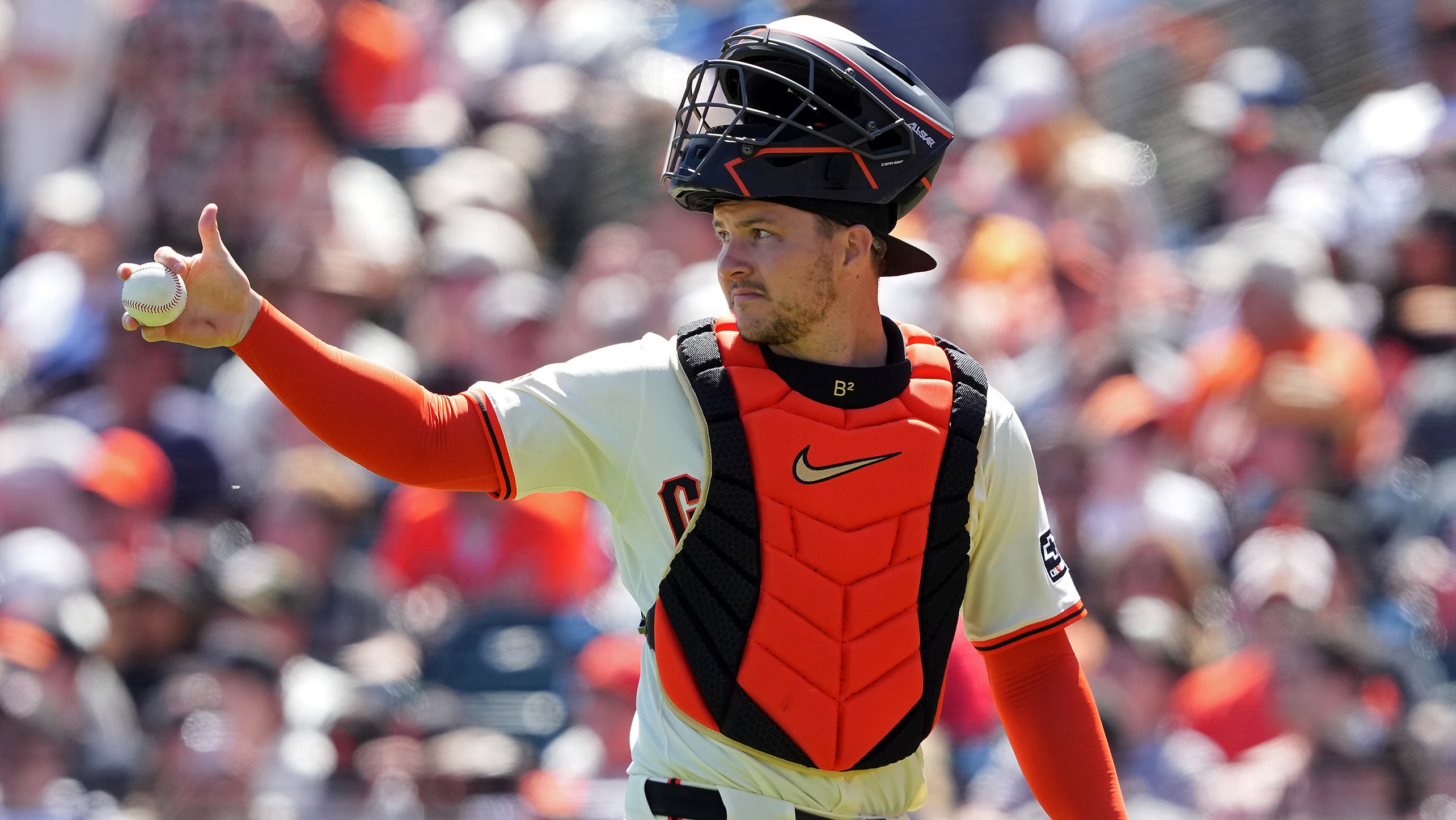 Patrick Bailey in catcher's gear holding a baseball