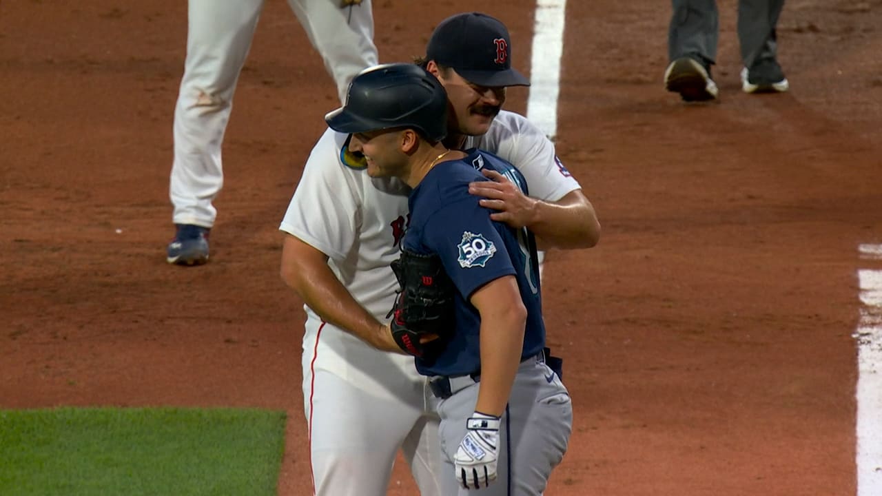 Red Sox pitcher Payton Tolle hugs Mariners batter Dominic Canzone
