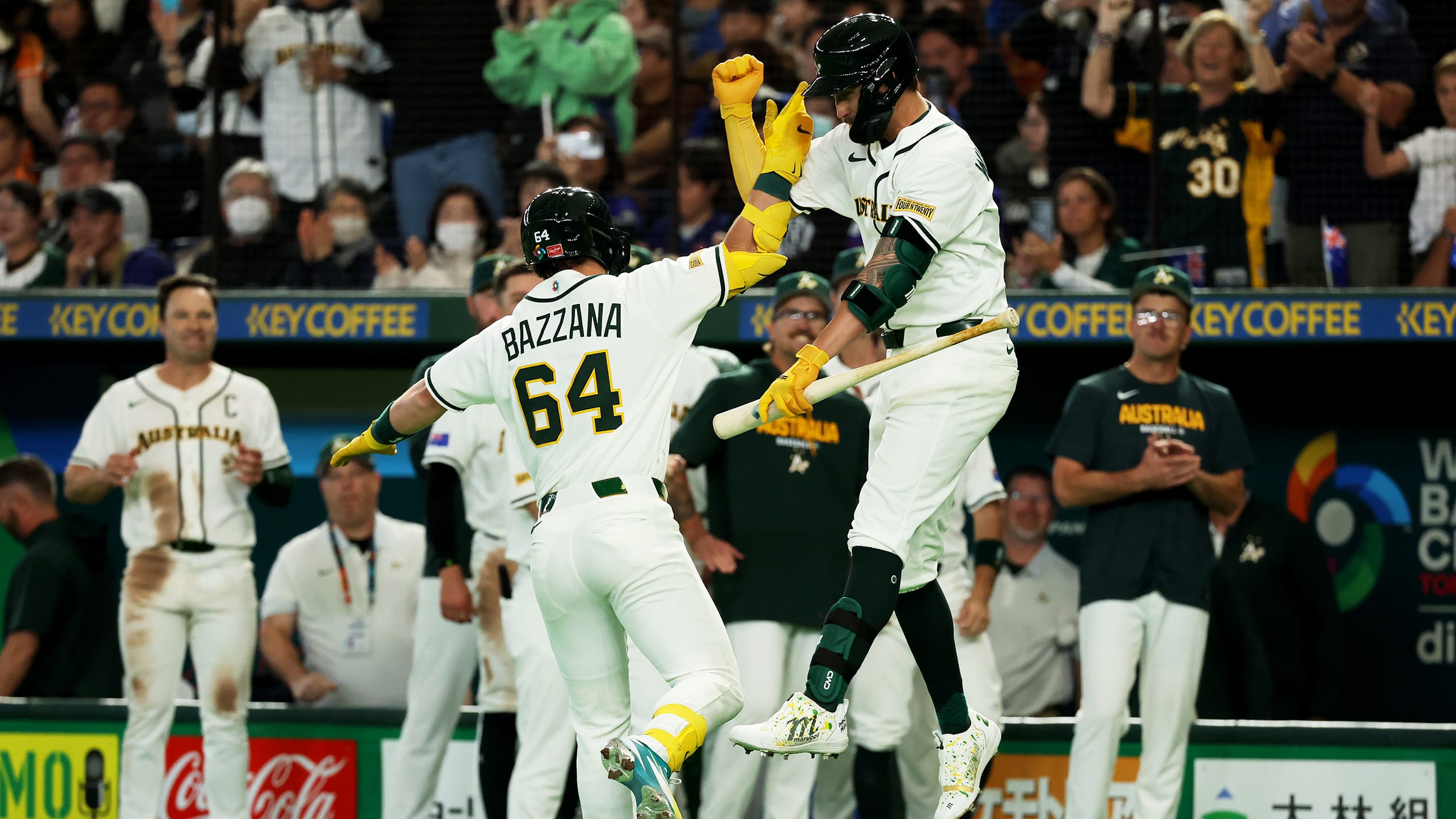 Travis Bazzana is greeted at home plate after hitting a home run
