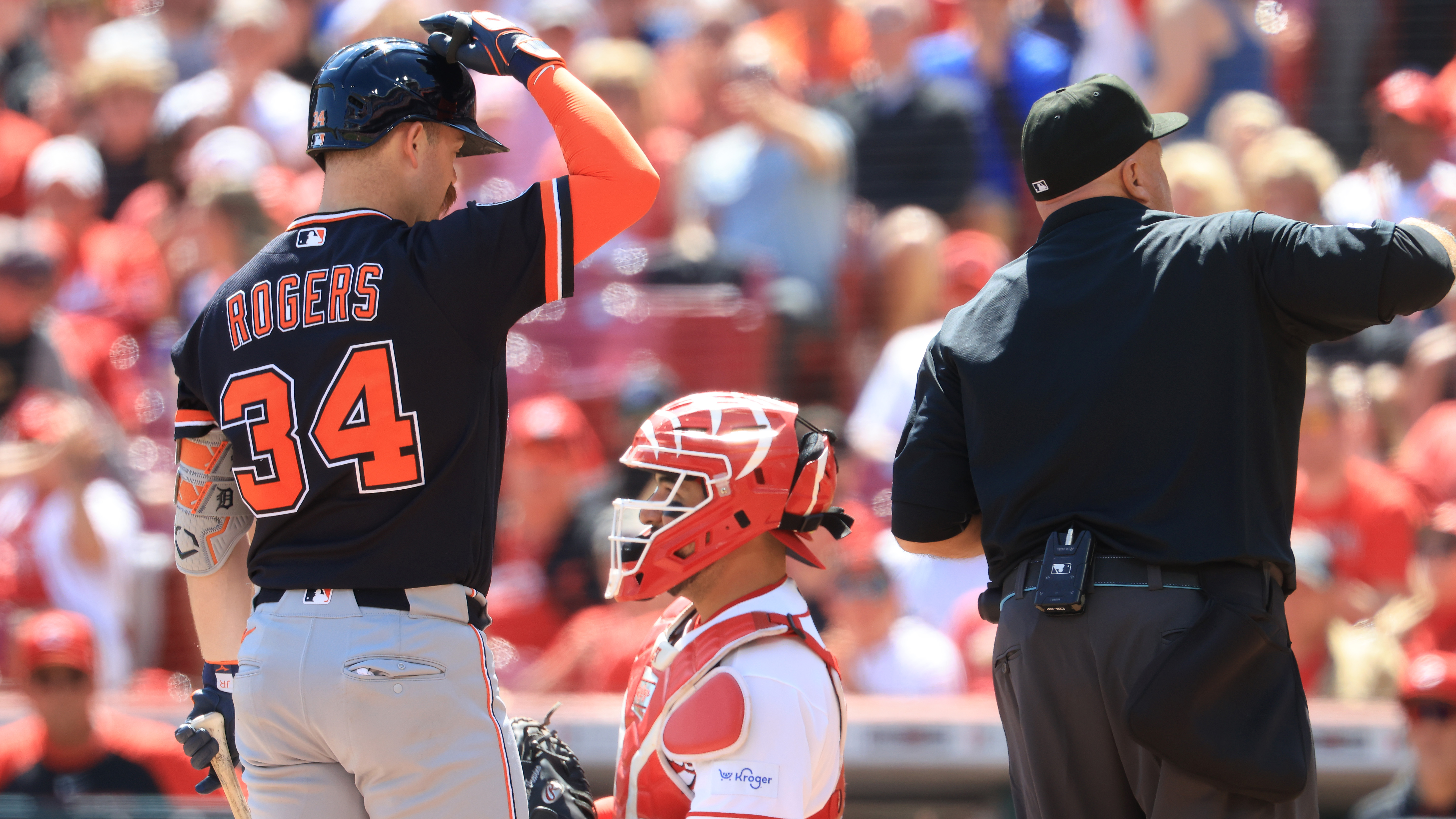 Tigers batter Jake Rogers taps his helmet to challenge a pitch
