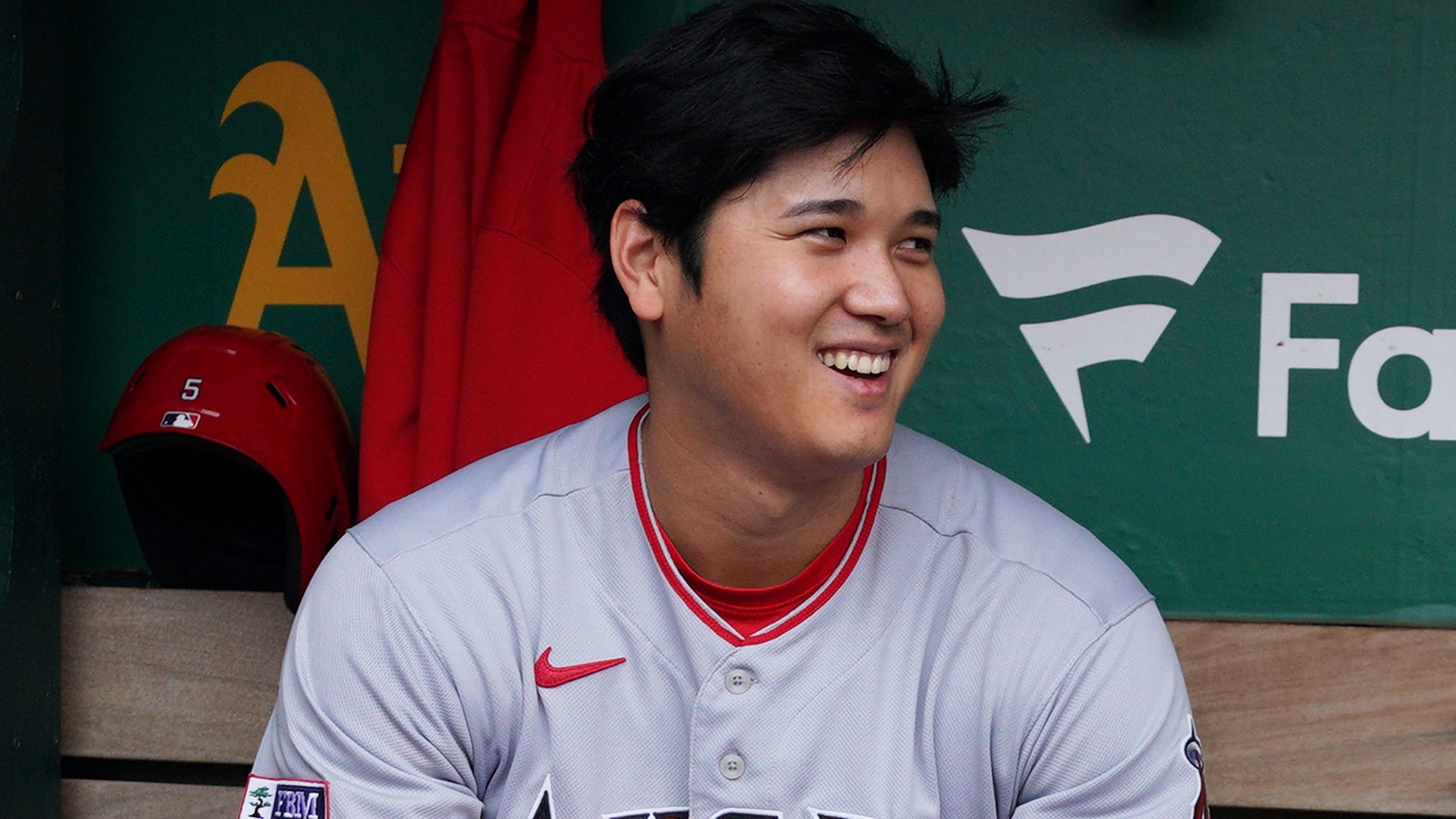 Shohei Ohtani seated in a dugout