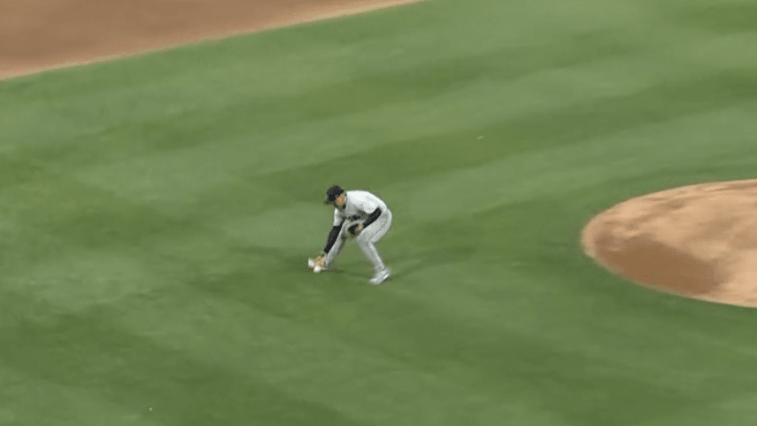 Jhonathan Diaz, a left-handed pitcher, picks up a ground ball with his right hand