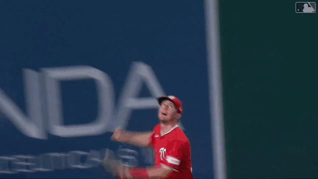 An animated gif of Jacob Young climbing the wall to rob a home run