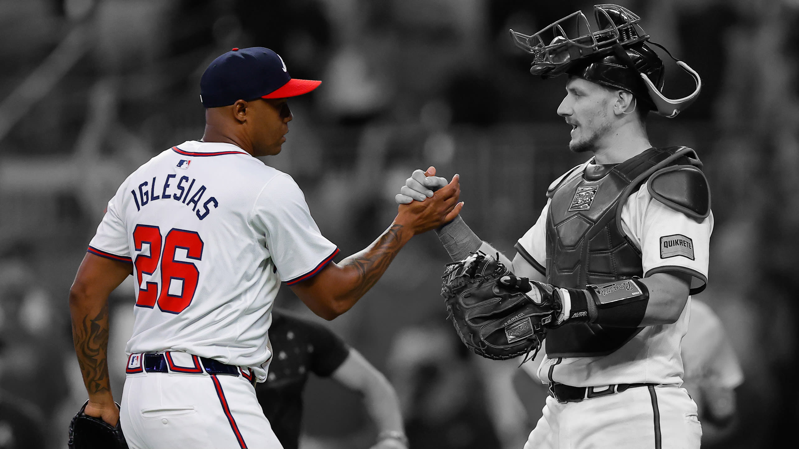 Raisel Iglesias is congratulated by catcher Sean Murphy