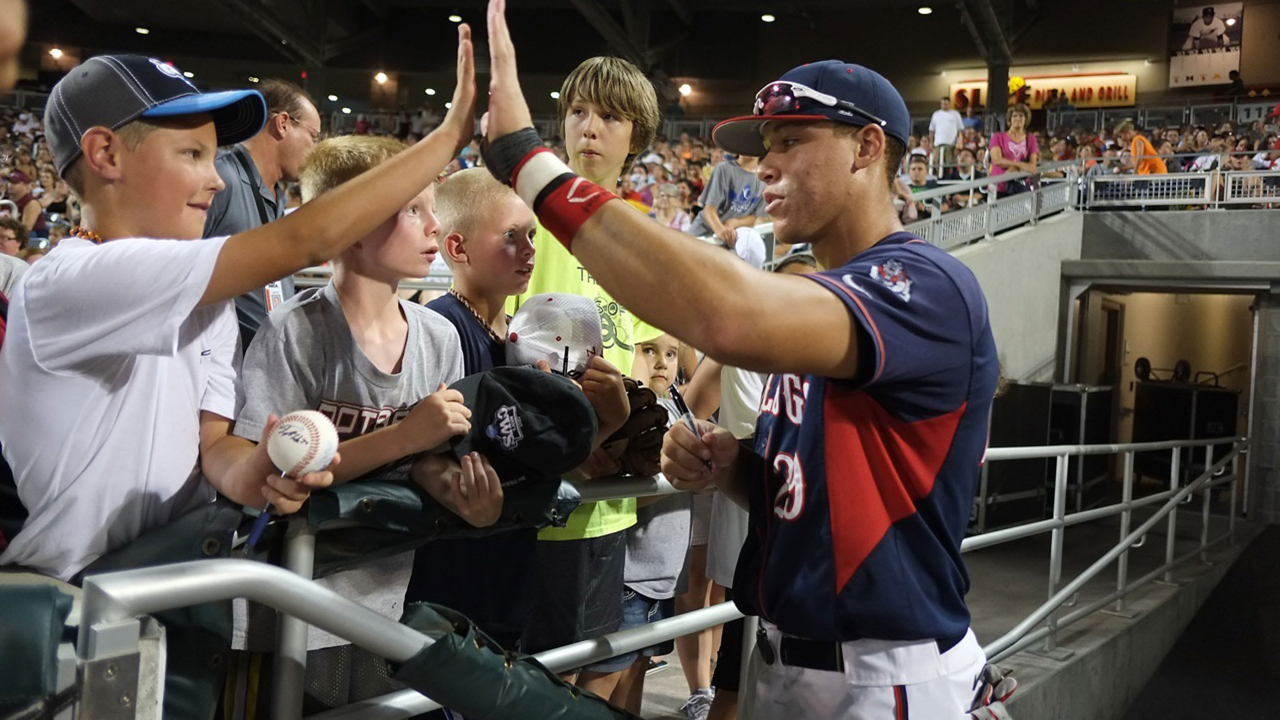 Aaron Judge high-fives a fan back in his college days