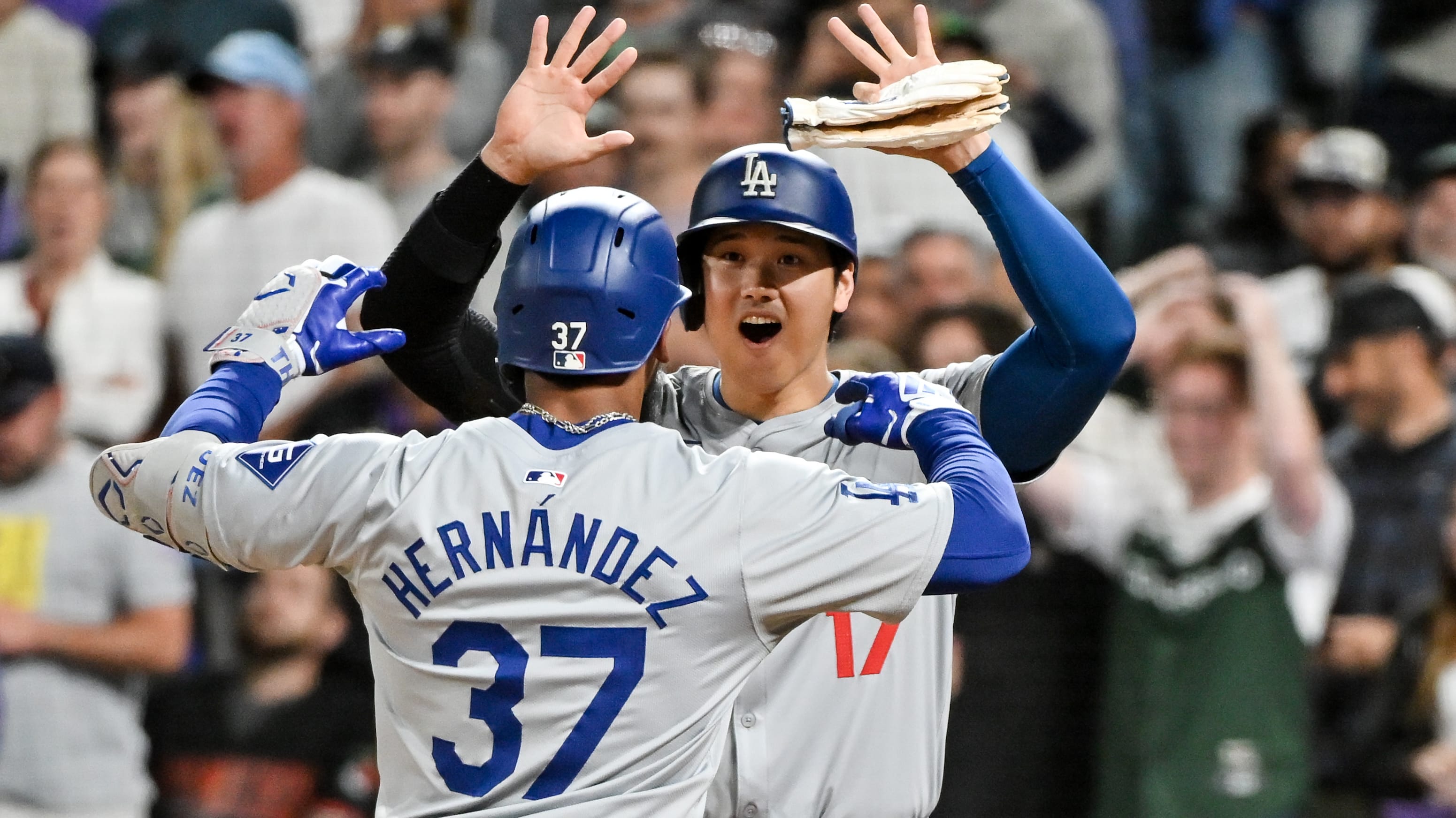 Shohei Ohtani greets Teoscar Hernández at the plate after his go-ahead homer