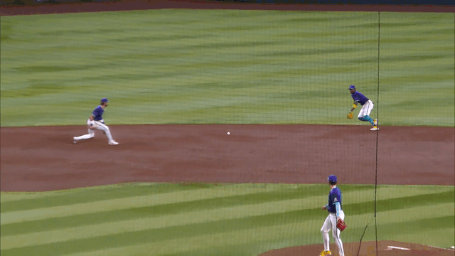 An animated gif of Geraldo Perdomo diving to his right and making the throw to first