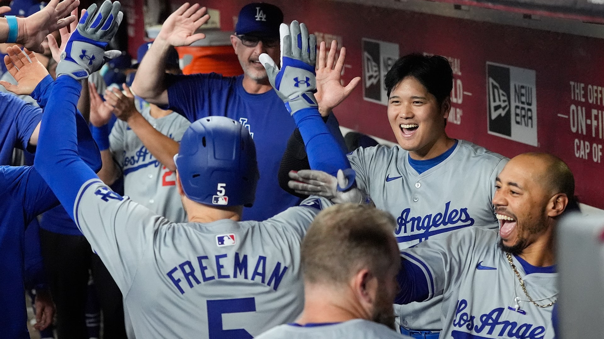 The Dodgers celebrate in the dugout