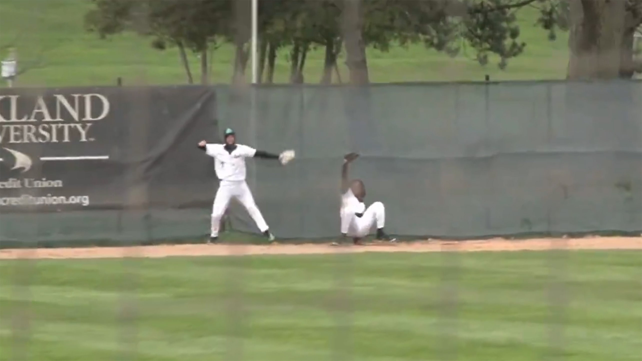 Two Oakland University outfielders celebrate