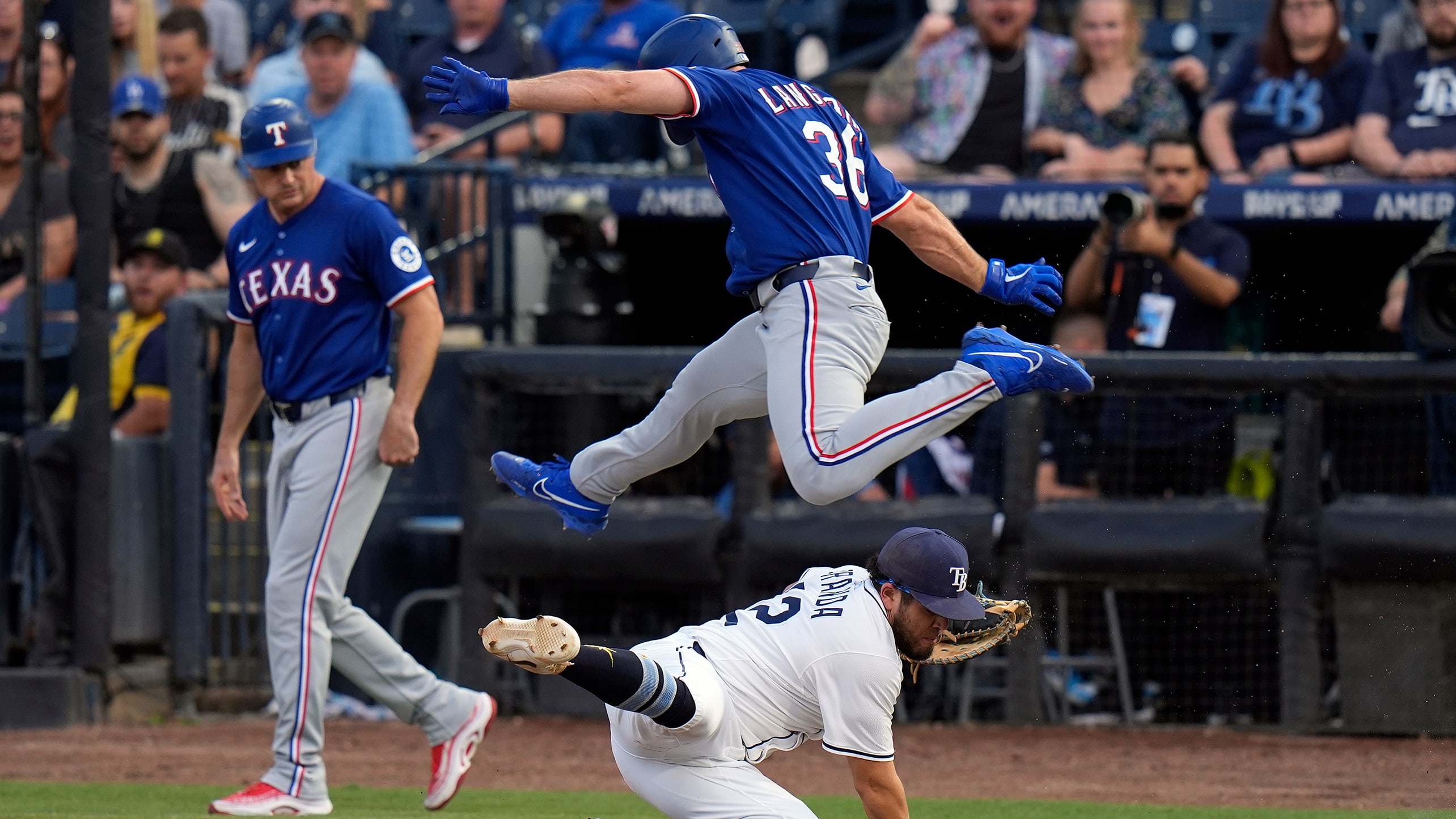 Wyatt Langford leaps over Rays first baseman Jonathan Aranda
