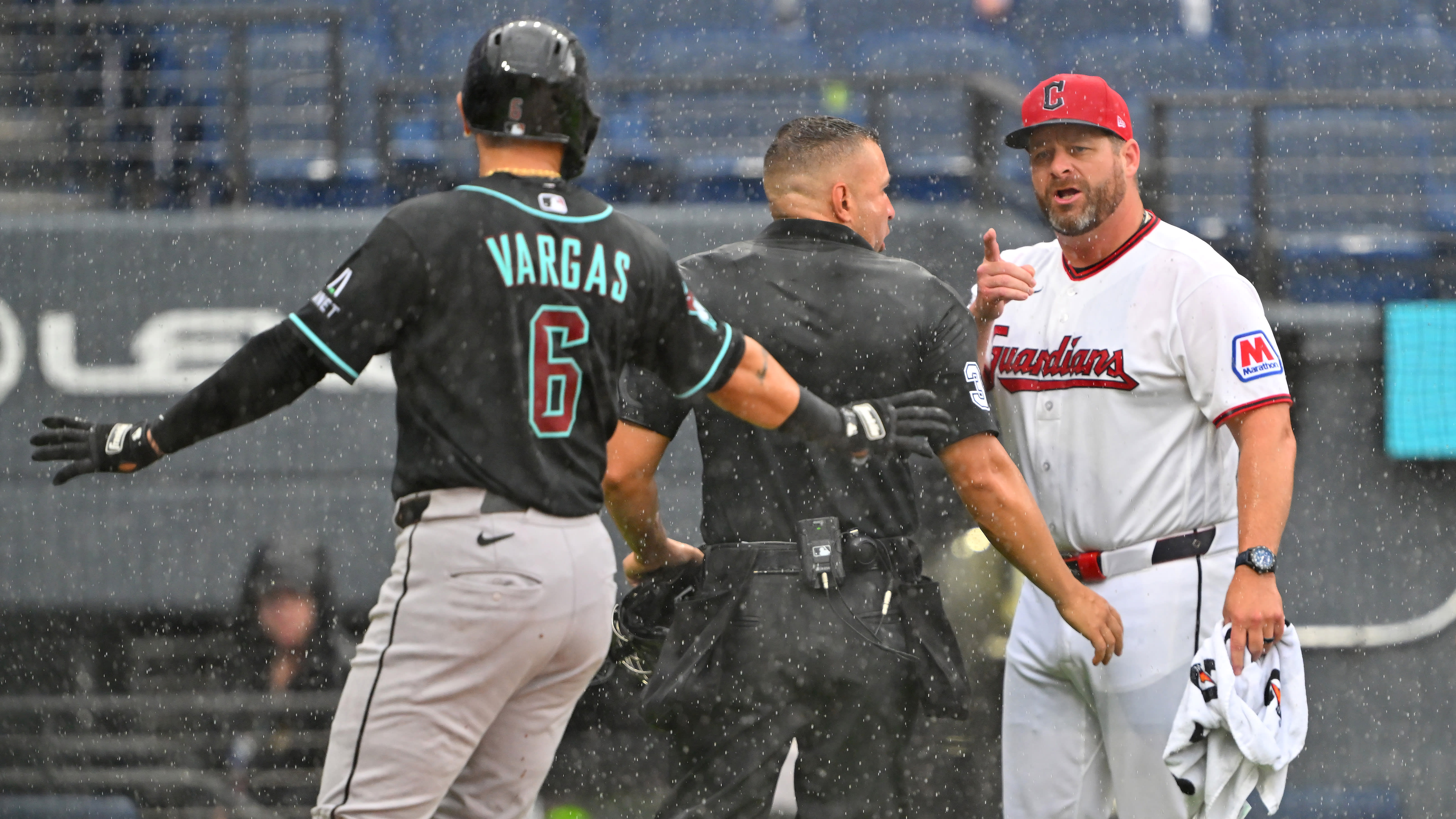 Guardians manager Stephen Vogt points toward the Diamondbacks' Ildemaro Vargas