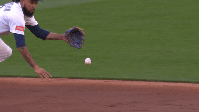 An animated gif of J.P. Crawford making a sliding stop and flipping the ball with his glove to second base