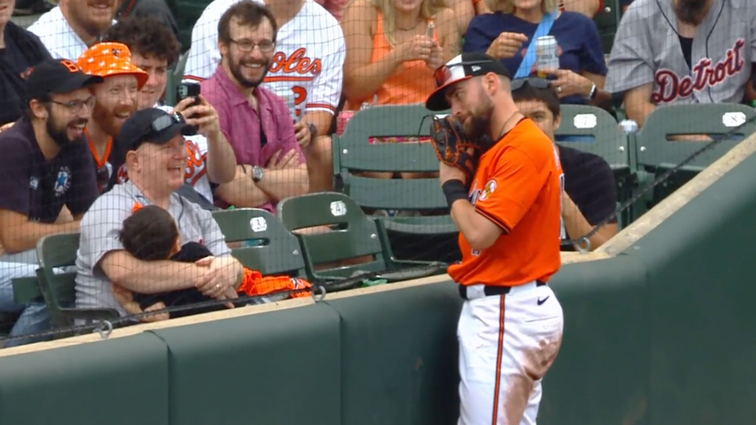 Colton Cowser gestures toward a sleeping child