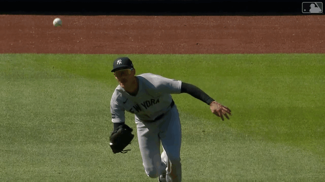 An animated gif of Cody Bellinger making a running shoestring catch