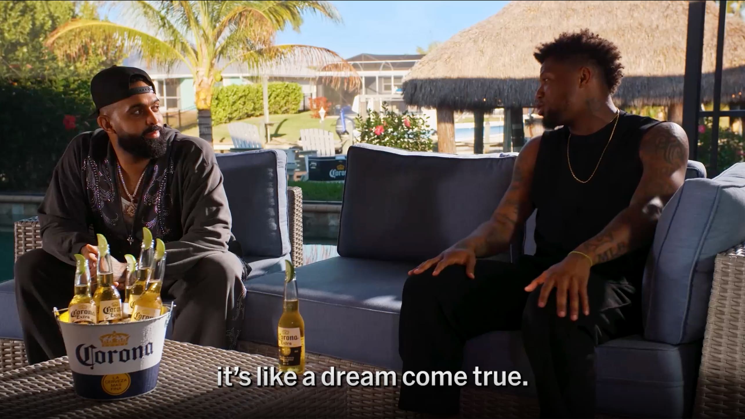 Eladio and Ronald Acuña Jr. talk on a patio
