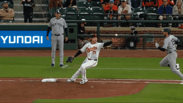 An animated gif of Dietrich Enns making a barehanded play at first base