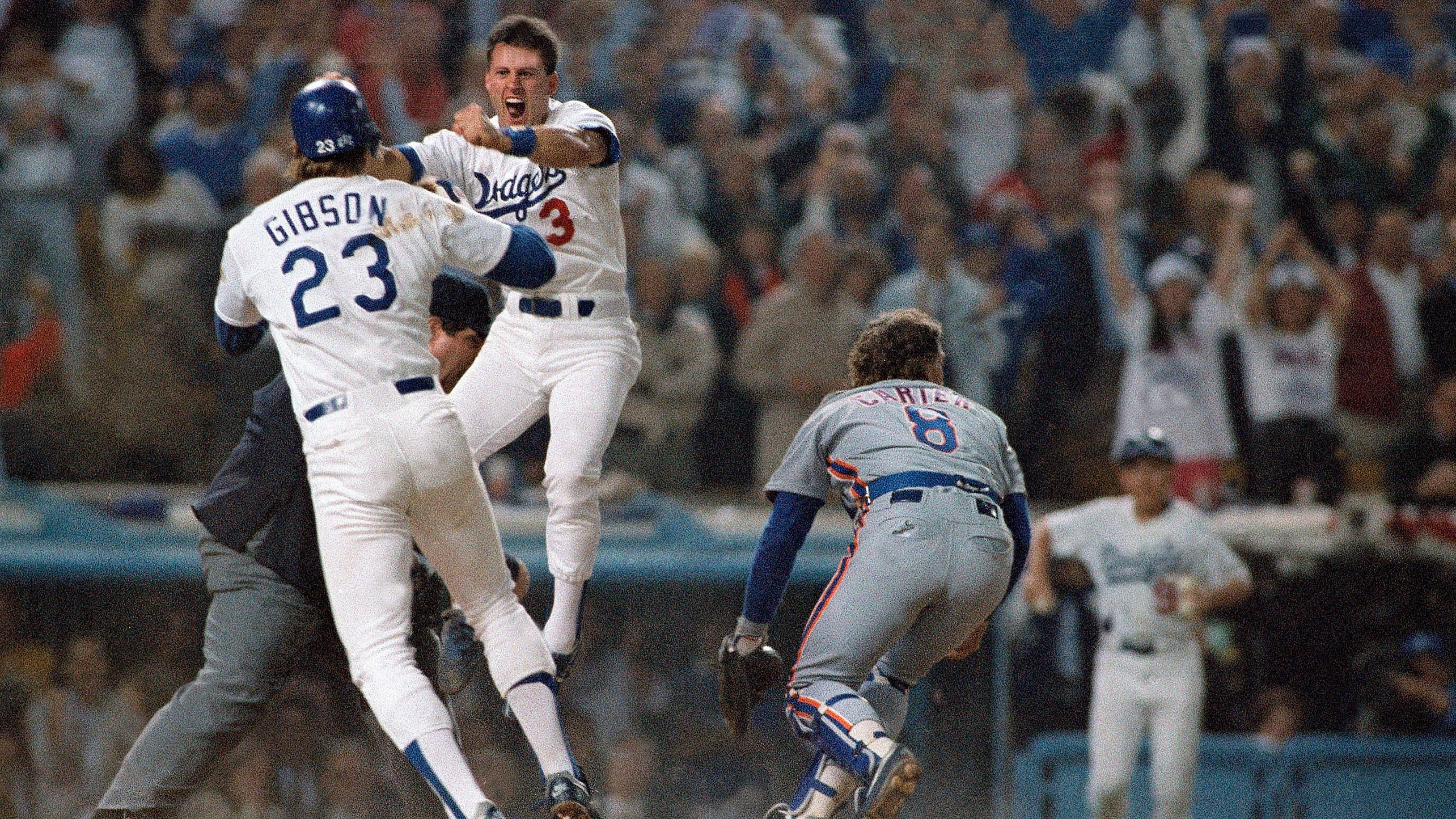 Kirk Gibson and Steve Sax celebrate near home plate