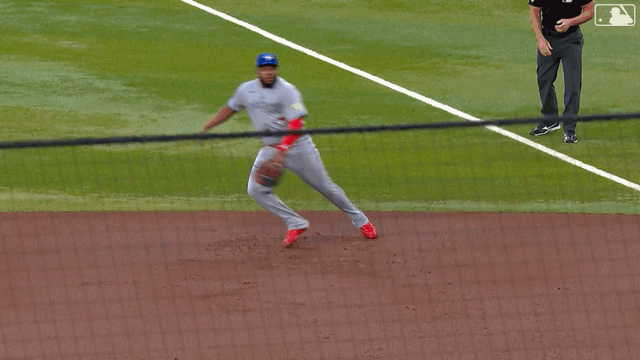An animated gif of Vladimir Guerrero Jr. making a diving catch and rolling on the dirt