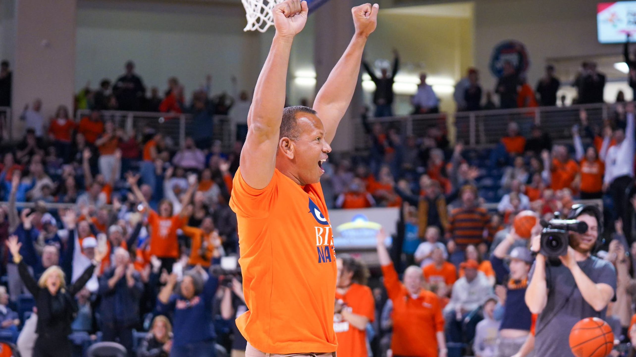 Alex Rodriguez celebrates after making a half-court basketball shot