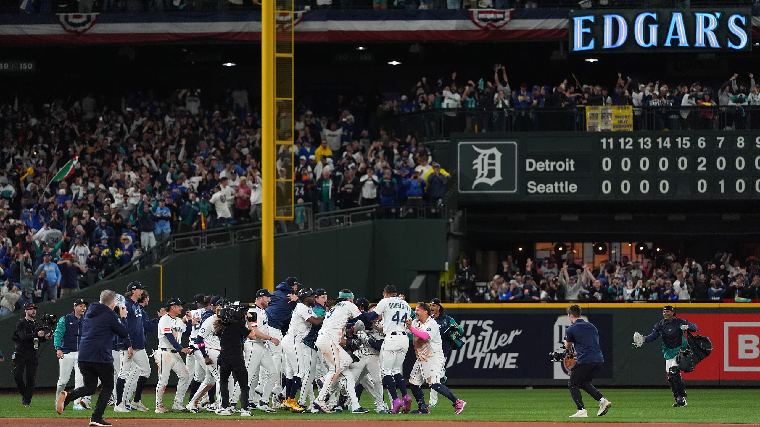 The Mariners celebrate on the field near second base