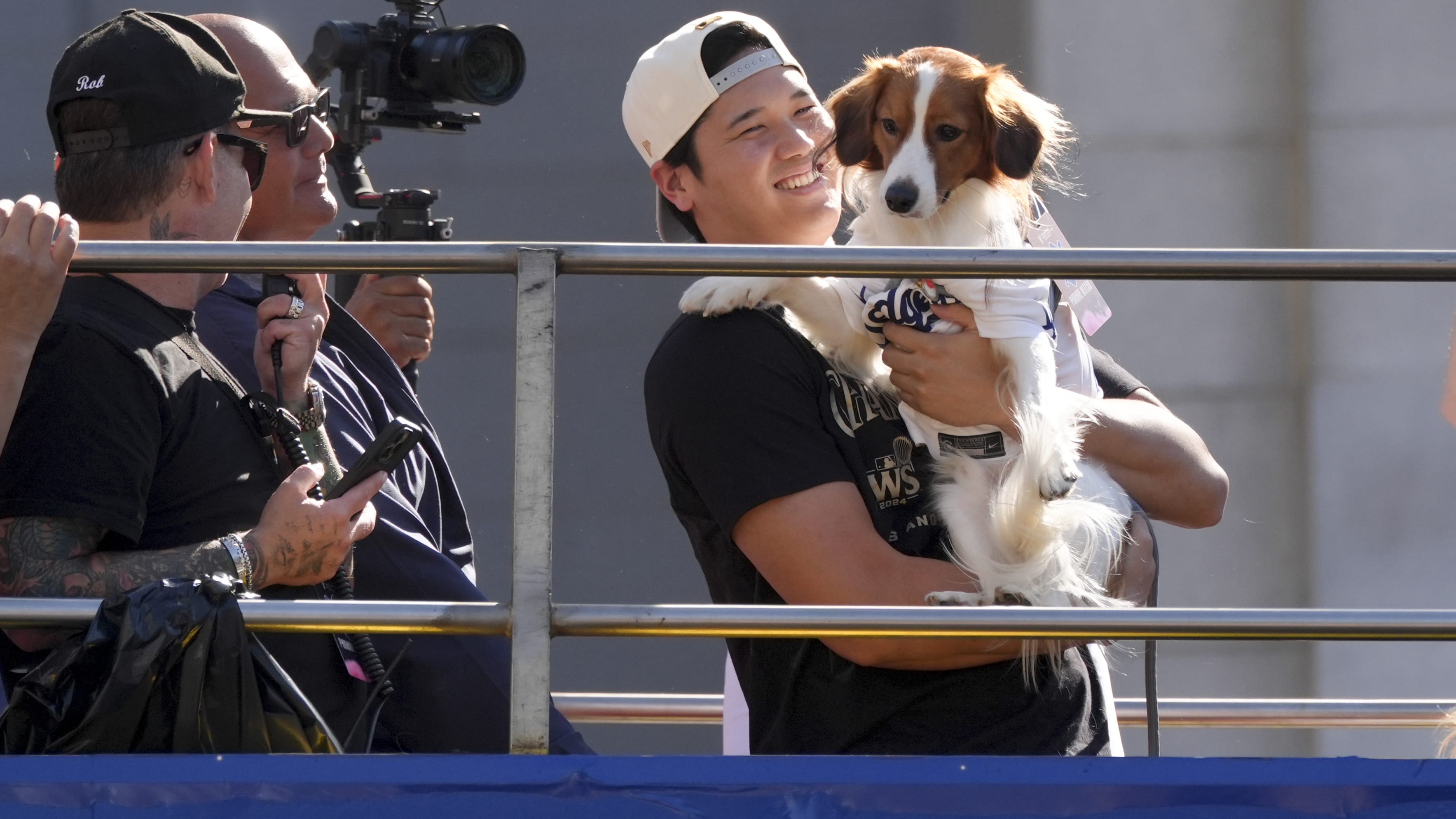 Shohei Ohtani holds his dog Decoy for all the fans to see at the LA parade